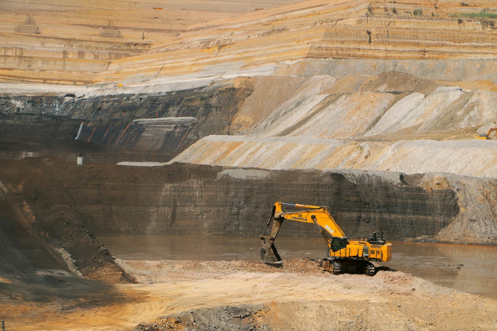 Excavator working in a large open-pit mine